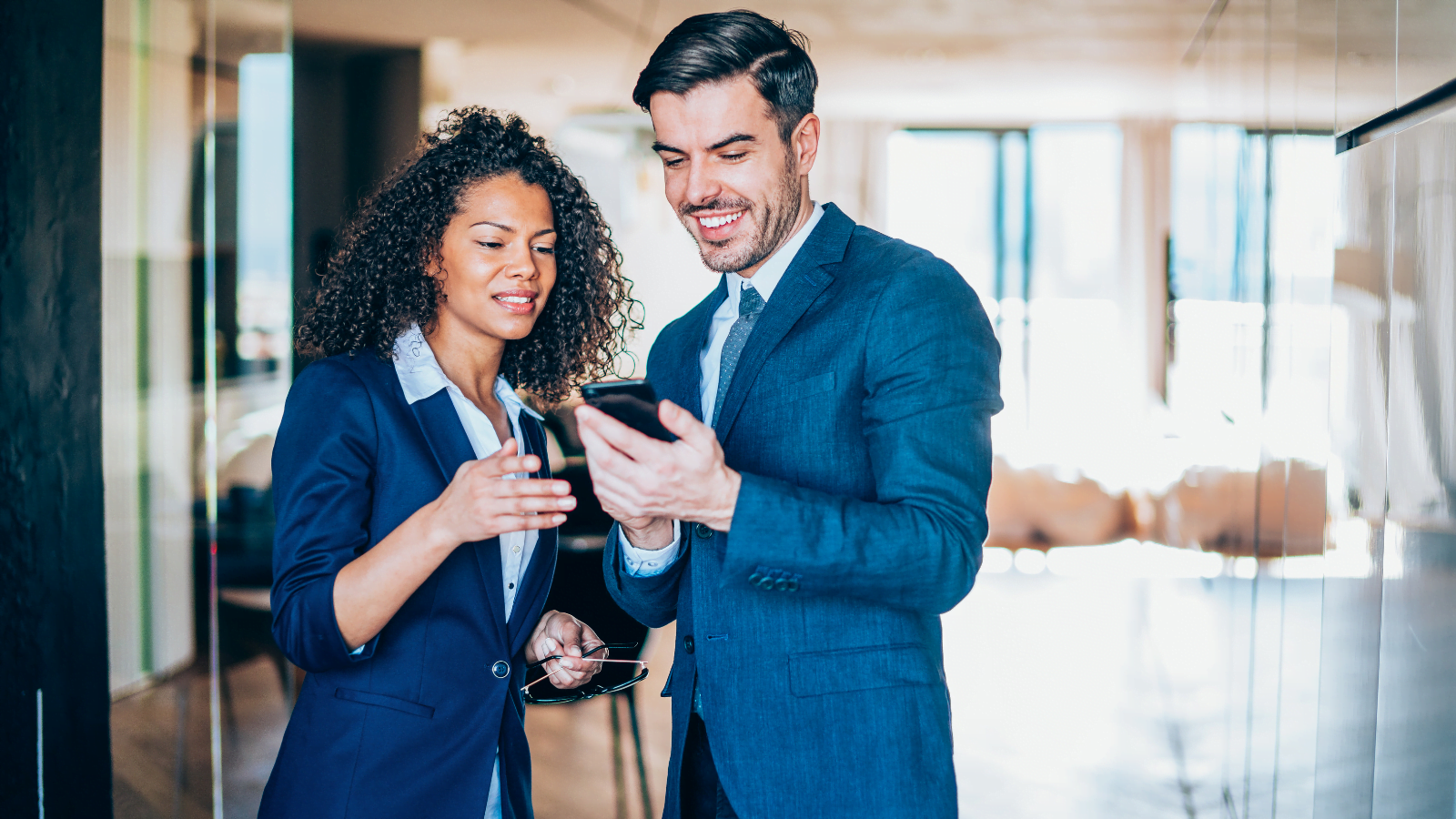 A man and a woman using a website on a mobile phone