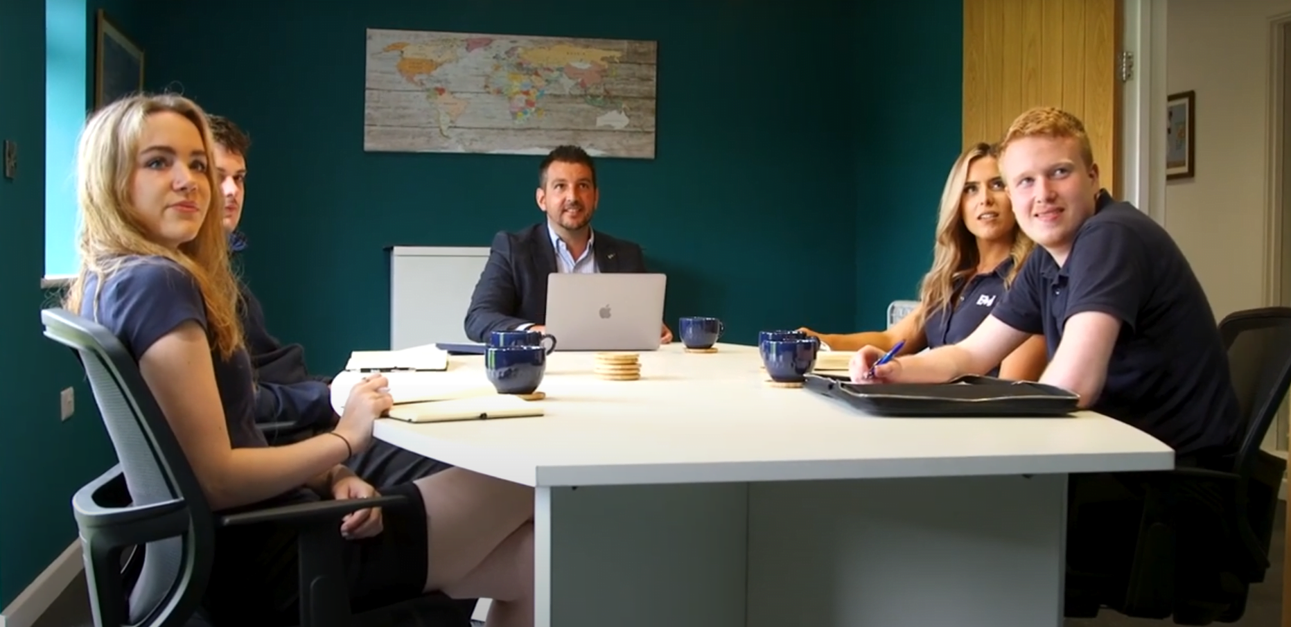 Picture of the Edworthy Media team sat around a desk.