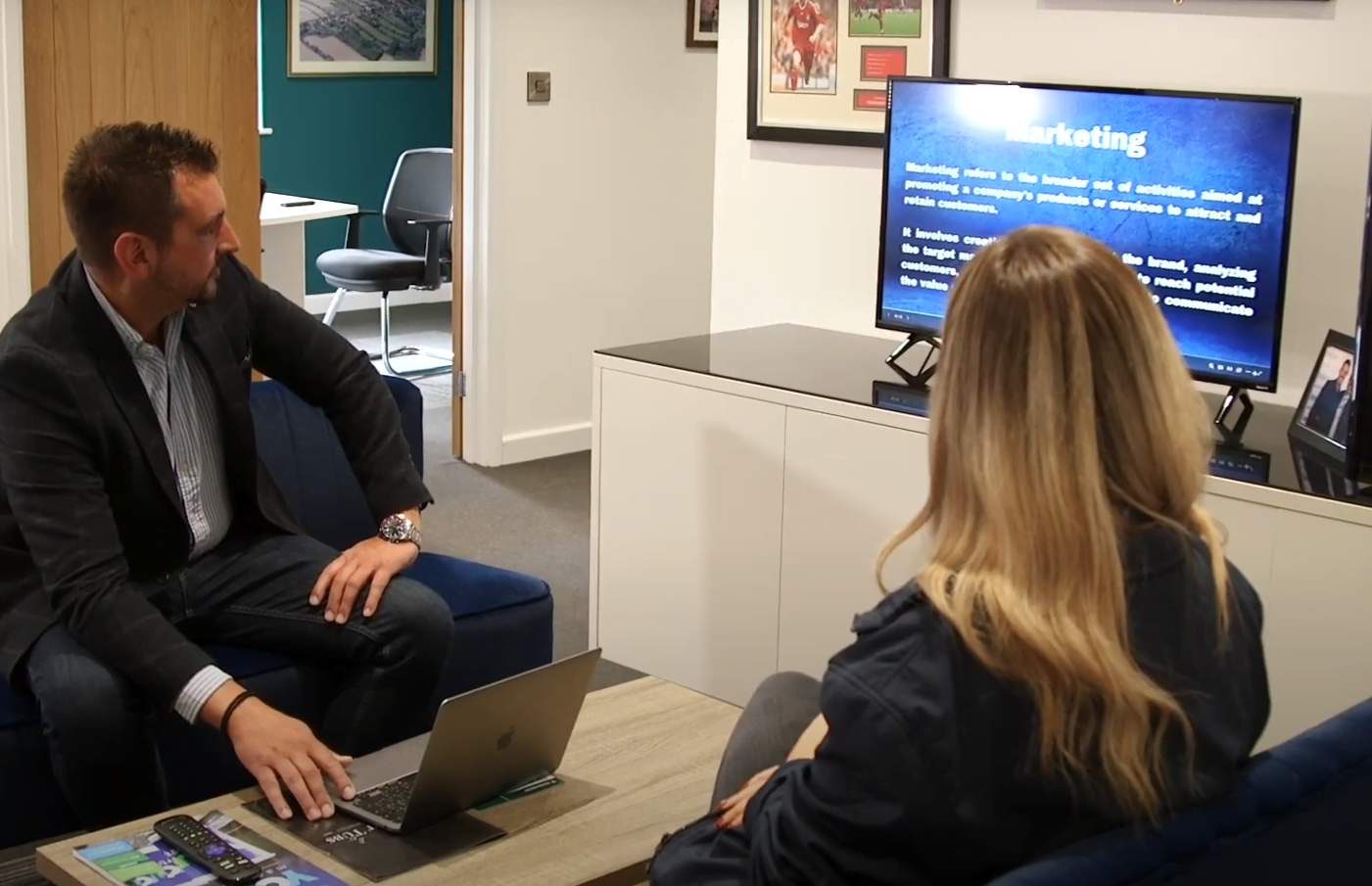 Two members of a team viewing a marketing presentation