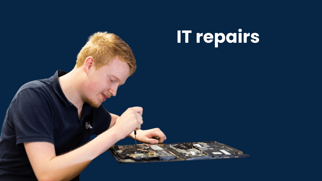 Technician using a screwdriver to work on the internal components of a laptop.